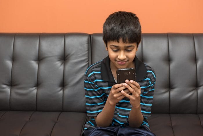 Boy texts on phone to be accountable for practicing music