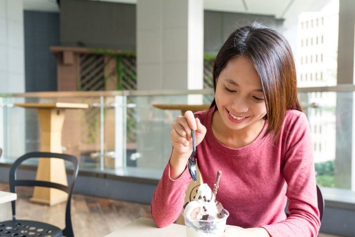 Woman eats ice cream as a reward for practicing music